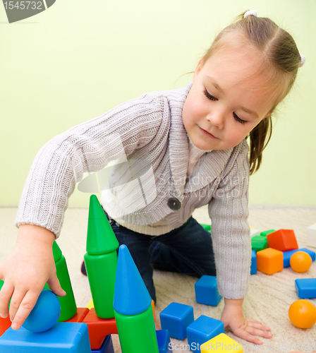 Image of Little girl is playing with toys in preschool