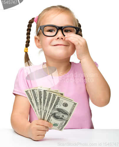 Image of Cute little girl with paper money - dollars