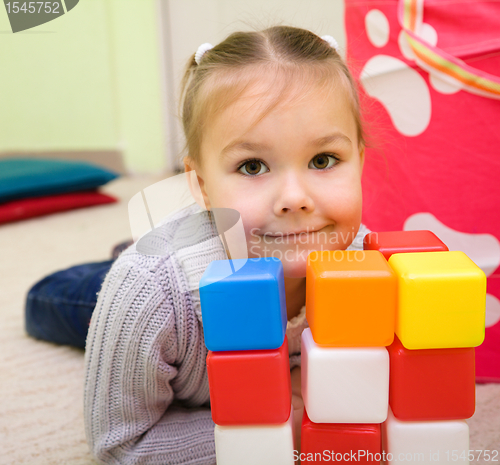 Image of Little girl is playing with toys in preschool