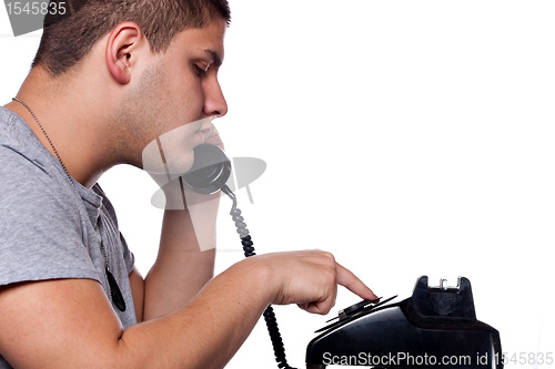 Image of Man Dialing Old Rotary Telephone