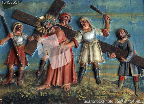 Image of Simon of Cyrene carries the cross