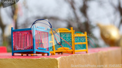 Image of Bird cages at Buddhist temple