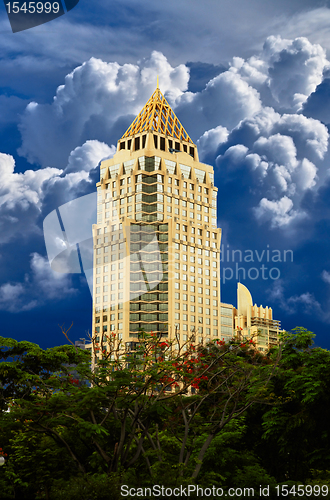 Image of Golden skyscraper on blue sky background