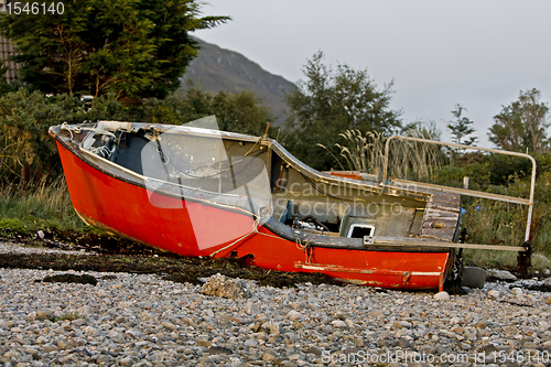 Image of read boat at coast