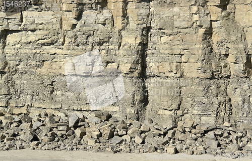 Image of light brown stone pit wall