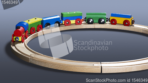 Image of colorful wooden toy train on tracks