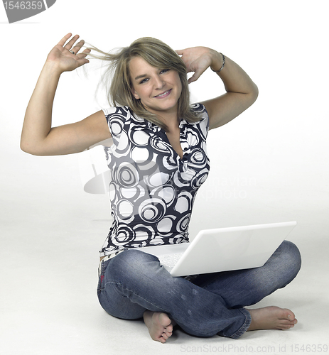 Image of cute blond computing girl takes a break