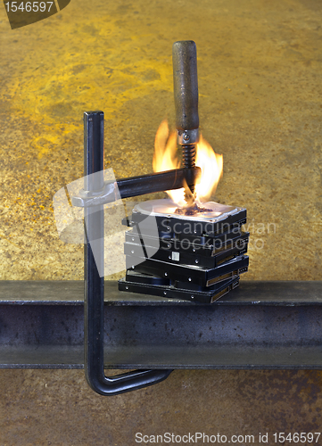Image of burning vise and hard disks