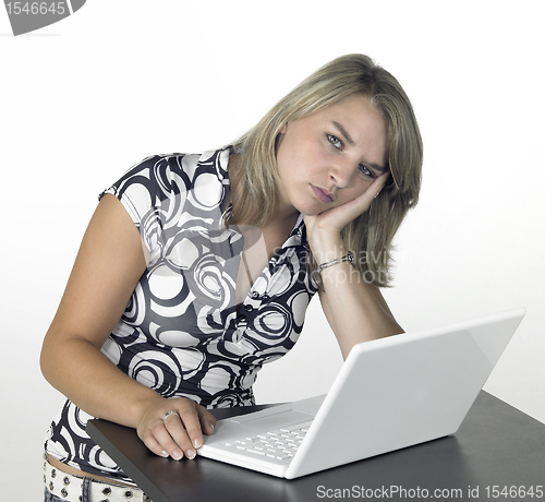 Image of blond computing girl taking a break