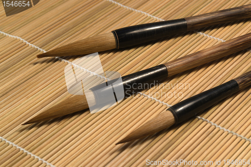 Image of chinese brushes on wooden mat detail