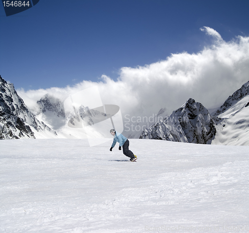 Image of Snowboarder descends a slope