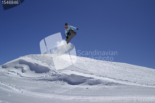 Image of Snowboarder jumping in terrain park