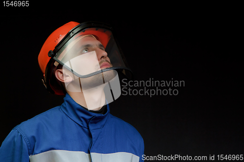 Image of The worker in overalls and a helmet