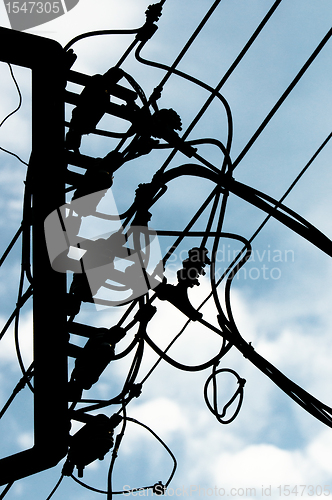 Image of Hihg voltage post against blue sky