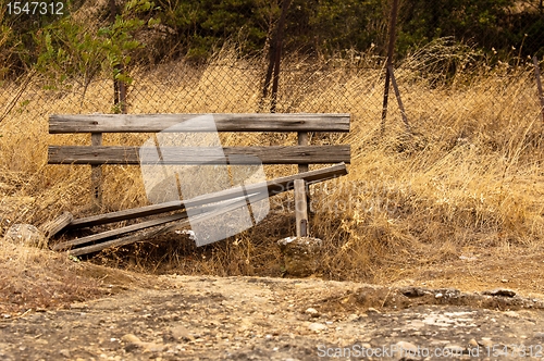 Image of A damaged bench in the park