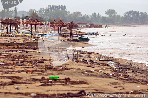 Image of A dirty polluted beach  in the rain