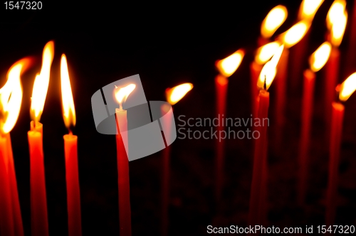 Image of Red candles in a row glowing
