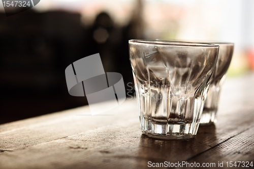 Image of Empty glasses on wooden bar