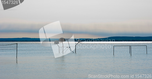 Image of Tranquil scene of a shore with some shilhouettes