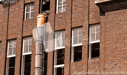 Image of Exterior of an industrial building with a large brick wall