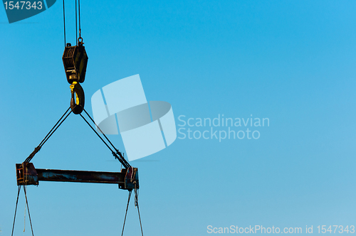 Image of industrial crane against blue sky