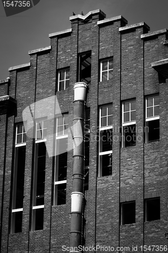 Image of Exterior of an industrial building with a large brick wall