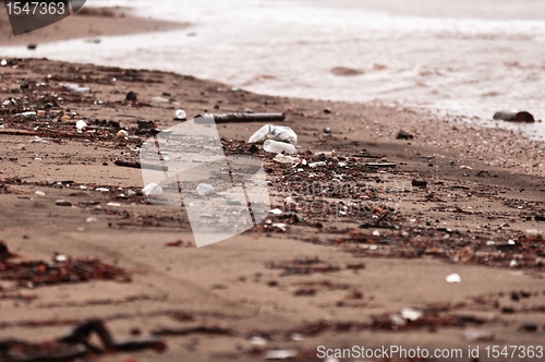 Image of A dirty polluted beach  in the rain