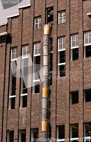 Image of Exterior of an industrial building with a large brick wall