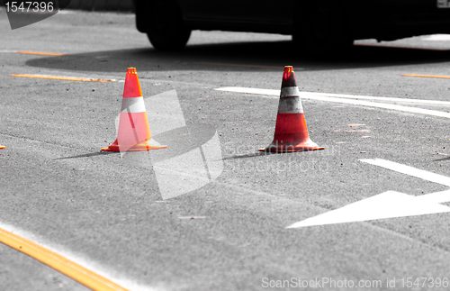 Image of Road block with white arrow showing the alternate way