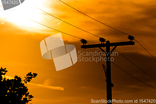 Image of High voltage post against sky at dusk