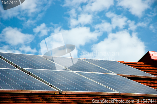 Image of Cells of solar energy panels on the roof of a building