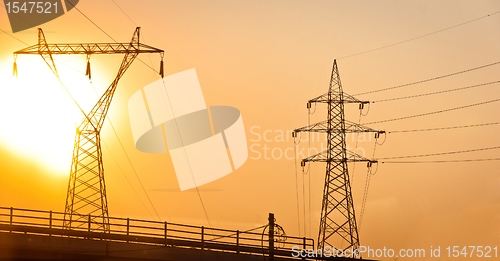Image of High voltage post against sky at dusk