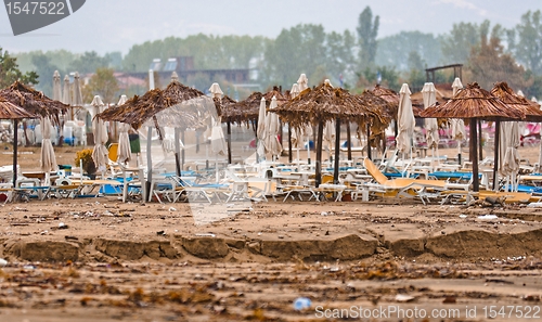 Image of A dirty polluted beach  in the rain