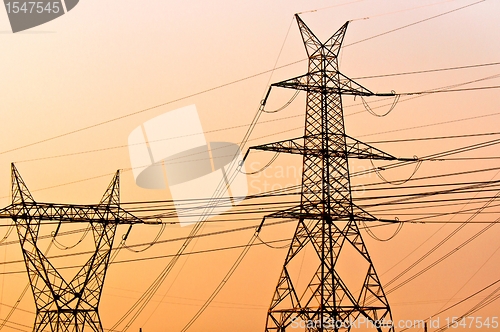 Image of Hihg voltage post against sky at dusk