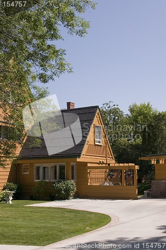 Image of Front of a House and its Driveway with Blue Skies on the Backgro