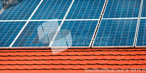 Image of Cells of solar energy panels on the roof of a building