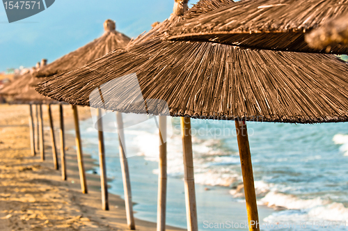 Image of Umbrellas on the beach with sea in the background