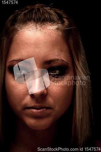 Image of Photo of a young woman against dark background