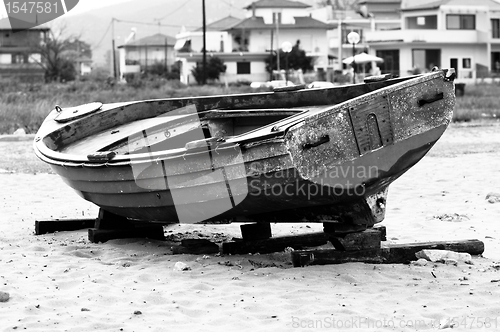 Image of Abandoned fishing boat on the shore in balck and white