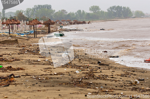 Image of A dirty polluted beach  in the rain