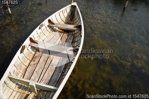 Image of Lonely boat floating on water at the bay