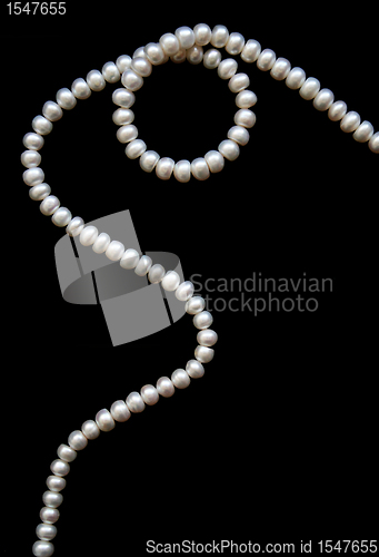 Image of White pearls on the black silk 