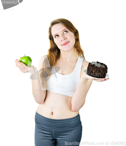 Image of Young girl holding apple and cake