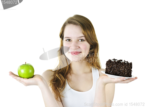 Image of Young girl holding apple and cake