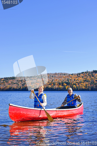 Image of Canoe trip on scenic lake in fall