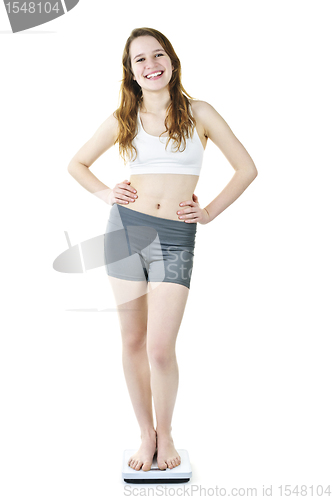 Image of Healthy young girl standing on bathroom scale