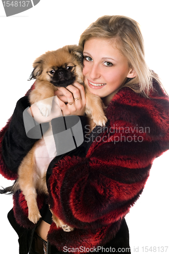 Image of Young woman holding a pekinese