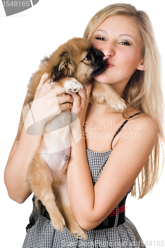 Image of Woman kissing her puppy