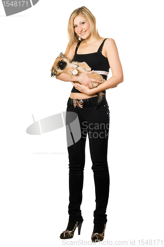 Image of Woman in black holding puppy