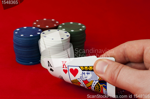 Image of Ace adn King high on red table and chips